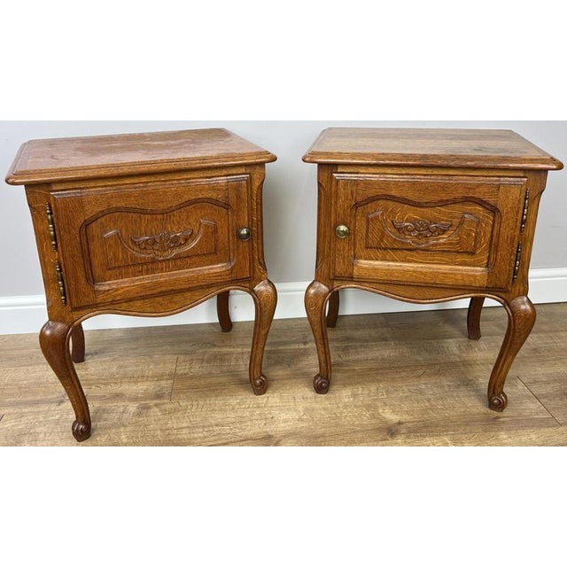 This elegant pair of Vintage French Louis bedside tables showcases timeless styling with a warm oak finish, beautifully...
