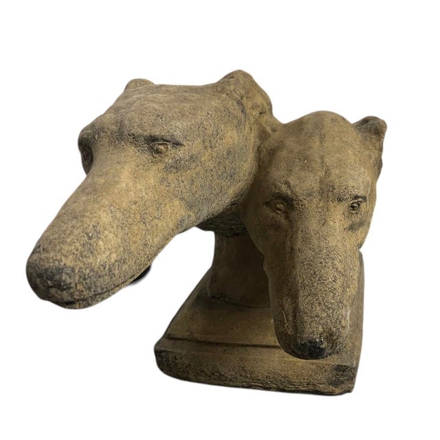 A compelling vintage cast stone sculpture featuring two overlapping sighthound heads (Greyhounds or Whippets), expertly...