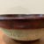 The product is a vintage mid-20th-century studio pottery stoneware bowl with a unique glaze. Handmade with a round shape...