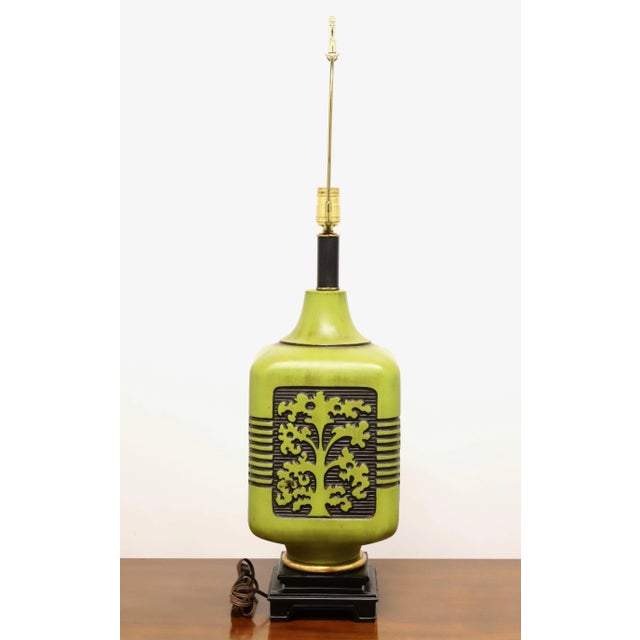 An Asian inspired table lamp, unbranded. Made of ceramic in a rounded square shape, green and black in color with Tree of...