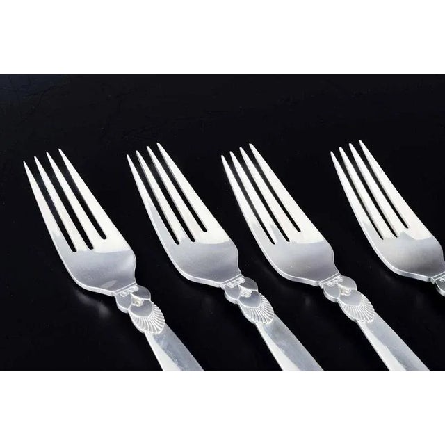 Georg Jensen. Four large dinner forks in the “Cactus” pattern. Sterling silver. Designer: Gundorph Albertus Pattern:...
