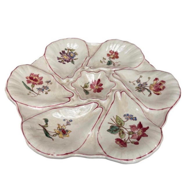 Majolica oyster plate with different flowers on each shells, circa 1900 signed Longchamp.