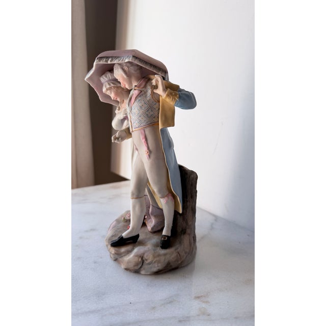 18th-Century Courting Couple Sharing a Parasol Under Pastel-Colored Period Attire. Glazed and Matte Porcelain Figurine For Sale - Image 4 of 15
