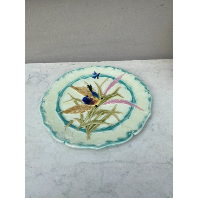 Lovely Majolica plate with bird and insect, leaves signed Saint Amand, circa 1890.