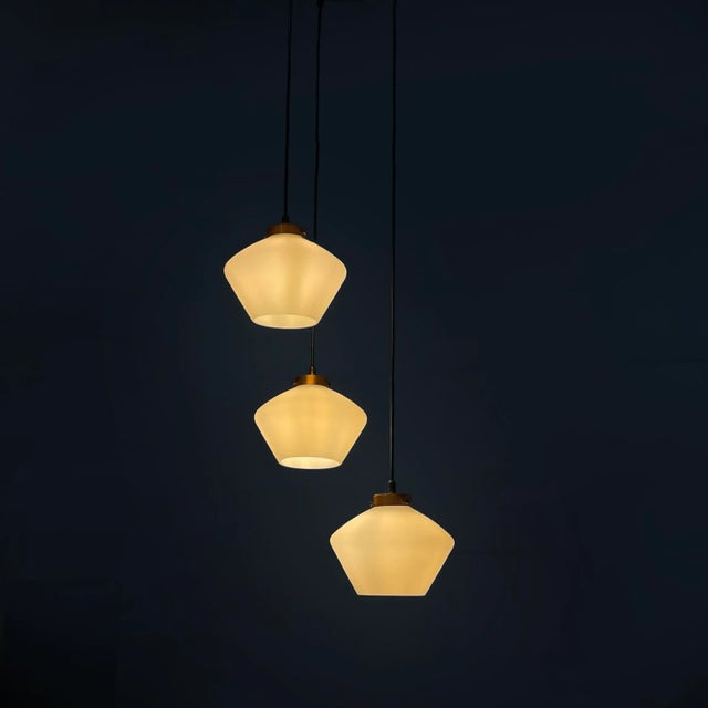 Italian mid-century modern three-light chandelier in glass and black metal, 1950s Three-light chandelier with opaline...