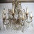 An elegant and richly ornamented twelve-light chandelier in the French Louis XV taste, featuring an elaborate scrolling...
