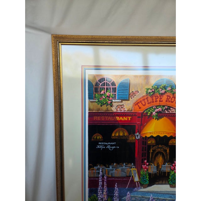 A vibrant Parisian streetscape by artist Arkady Ostritsky, titled Tulipe Rouge, capturing the warmth and romance of a...