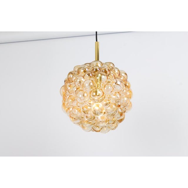 A round bubble glass pendant with light smoke tone designed by helena tynell for limburg, manufactured in germany, circa...