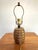 Charming midcentury brass lamp with a black neck, reminiscent of a woven basket with straps. The aged brass allows this to...
