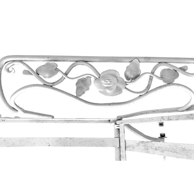 Antique Hollywood Regency Garden Chaise Lounge in Iron with floral details in white. Attributed to John Salterini. It has...