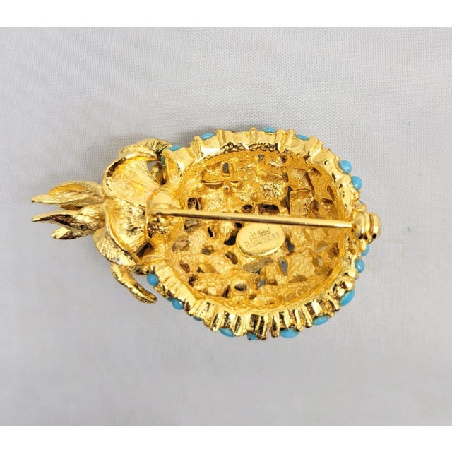 1960s goldtoe cabochon faux-turquoise with small round clear rhinestone accents pineapple brooch with security clasp....