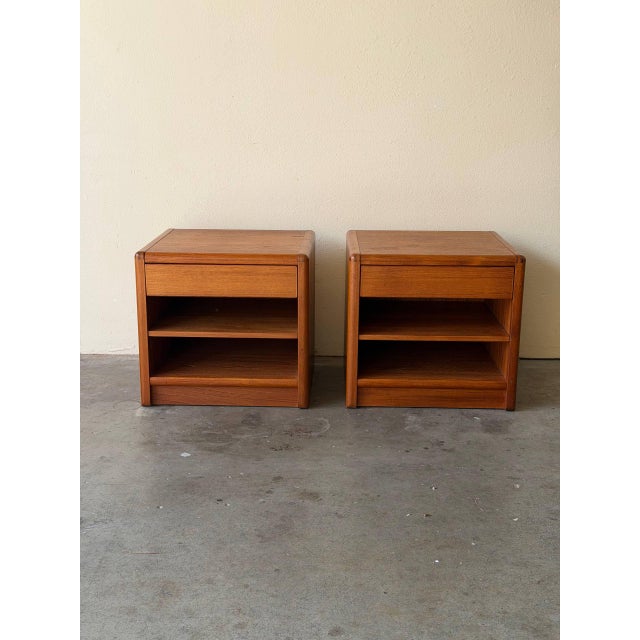 Beautiful pair of vintage Mid-Century Modern nightstands, crafted in warm teak with clean Scandinavian lines. These...