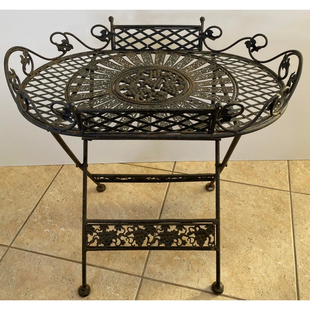 Antique French Style Folding Wrought Iron Garden Table with Grapevine Motif, Oval Pierced Top, Circa 1900 A highly...