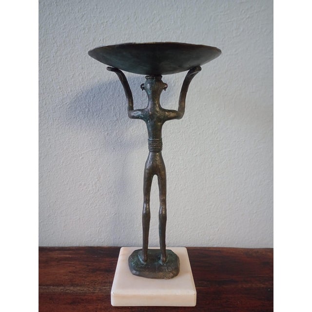 This is a bronze replica of the "Goddess" crafted by an artisan named Gert Albrecht. It is a tall central female figure...