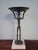 This is a bronze replica of the "Goddess" crafted by an artisan named Gert Albrecht. It is a tall central female figure...