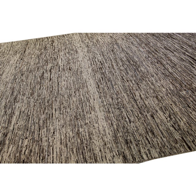 This hand-knotted wool rug, highlighted with an alluring Moroccan pattern, offers contemporary appeal. The blend of...