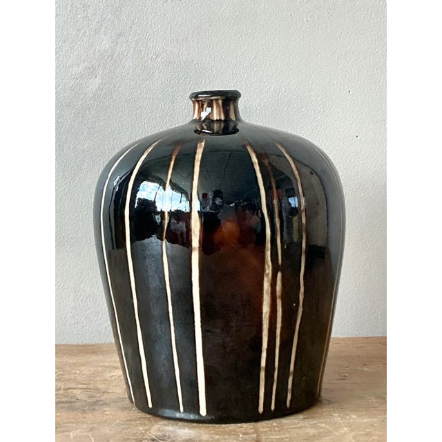 Introduce a touch of artisanal elegance to your home with this vintage Boho Chic glazed ceramic vase. Crafted with a...