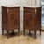 A fine pair of French Louis XVI style antique nightstands in mahogany, combining geometric marquetry, original marble tops...