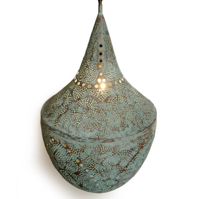 Beautiful verdigris handmade copper lantern with perforated decorative design that emanates intricate light patterns. Open...