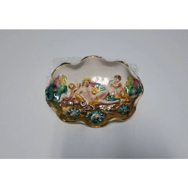 Italian ceramic jewelry dish with center classical Roman male relief scene, ruffled edge and gold trim. Made in Italy as...