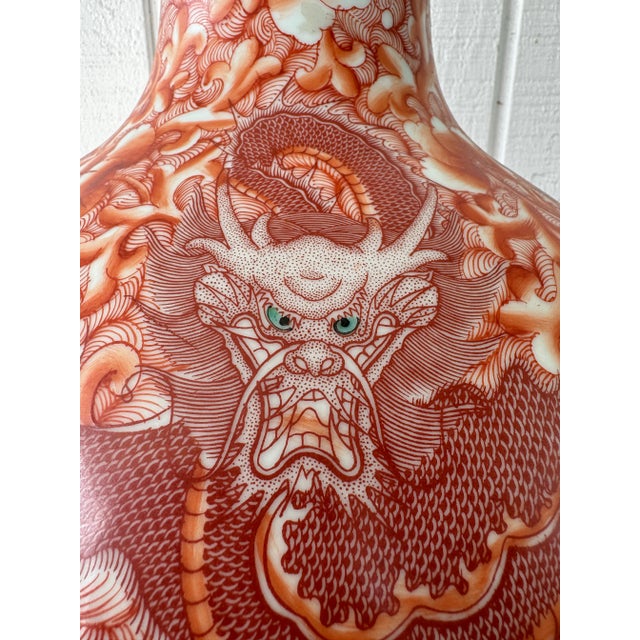 This stunning pair of vases surfaces are intricately decorated with vivid red dragons with green eyes that coil around the...