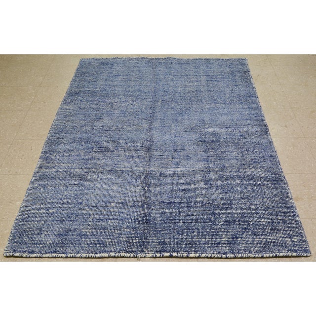 Hand-knotted with care using traditional rug making techniques, this wool rug blends timeless craftsmanship with a modern...