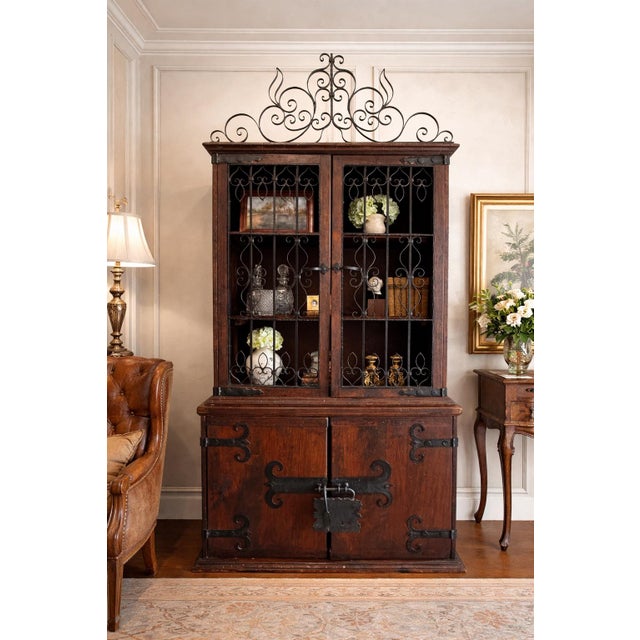 Striking monumental Spanish Colonial cabinet in richly toned rustic wood with dramatic wrought iron grille doors,...