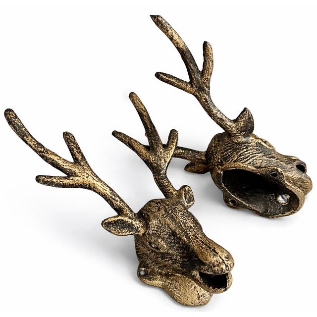 A pair of late 20th century stag head wall hooks in cast metal with bronze patina, sculptural and functional.