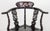 Chinese Export Mother-of-Pearl Inlaid Ebonized Corner Chair, the sweeping horseshoe-shaped crestrail centered by a prunus-...