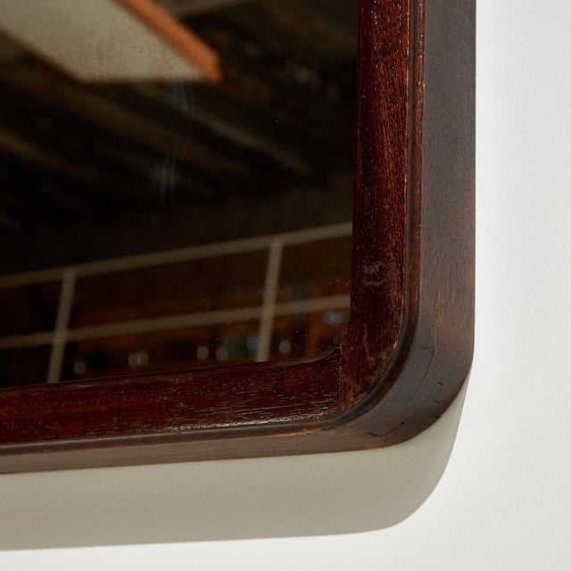 Stained oak framed mirror from the 1970s. with some surface scratches, stains and wear on the mirror and wooden parts.