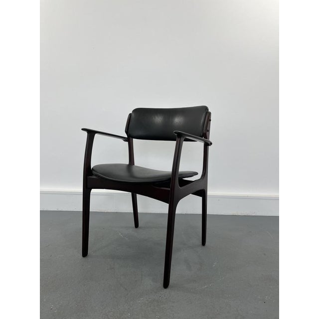 Erik Buch armchair in rosewood which is a testament to good design and craftsmanship. A solid rosewood construction with...