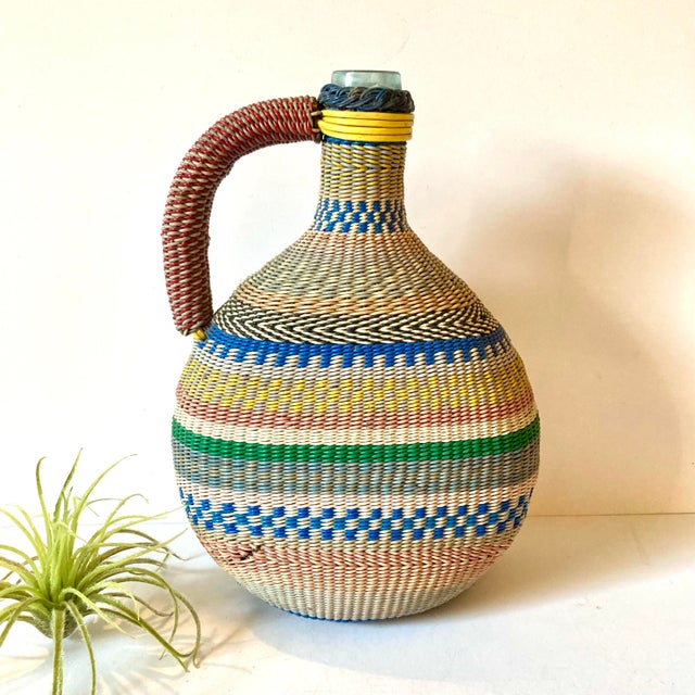 This colorful bottle is also known as a miner's bottle, Scoubidou, or Defiance bottle. These unique folk art items from...