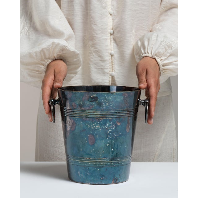 This mid 20th century ice bucket from France is finished in charcoal, worked in silver. Its form follows honest, well-...