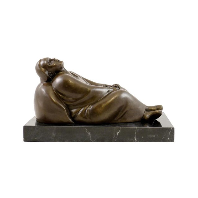 This solid bronze sculpture depicts a reclining woman with her head gently tilted back and her eyes closed. Produced using...