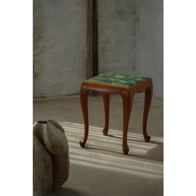 A charming pair of stools crafted in the Rococo style, featuring elegant cabriole legs and softly curved forms that...