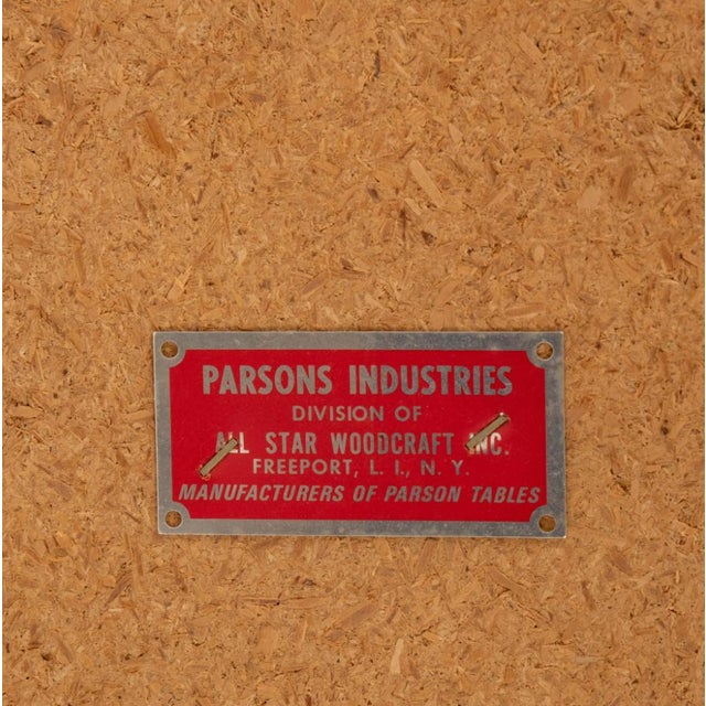 parsons industries, mid-century a classic parsons silhouette reimagined in warm burlwood veneer. the clean lines highlight...
