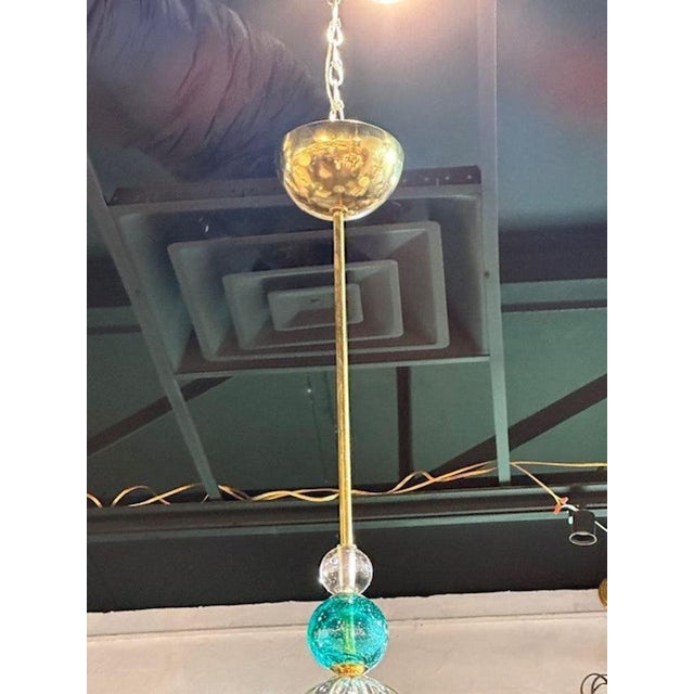 Pair of modern Murano texured champagne and turquoise glass and pendant lights. Sure to make a statement!