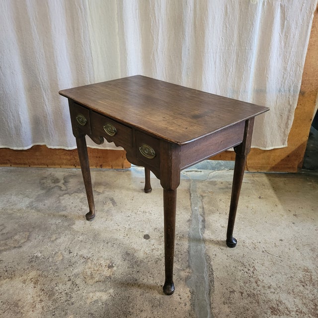 TThe patina on this George II Period Oak 3 Drawer Lowboy With Pad Feet gives it such character. Great as a side table or a...