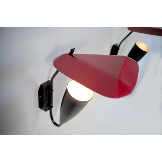 Large wall lamp in black and red lacquered metal, France, 1950. In the tradition of designers such as Jacques Biny, Michel...