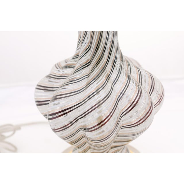 A striking pair of Murano style art glass lamps featuring a swirling ribbon pattern and sculptural contours. Their fluid...