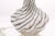 A striking pair of Murano style art glass lamps featuring a swirling ribbon pattern and sculptural contours. Their fluid...