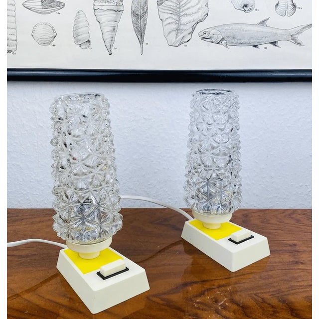 These two Space Age bedside lamps bring a true Space Age feel to your interior. Typical of the 1970s: the angular, cream-...