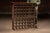 Early 20th century Wall-mounted oak mail sorter cabinet with numbered compartments, brass label holders, and glass front....
