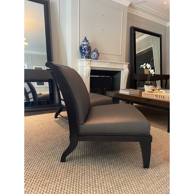 Set of four Holly Hunt H studio armless chairs. Upholstered in gray leather with wood ebony frame. Good condition with...