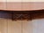 A beautifully carved mahogany server with a satinwood-banded serpentine top. The frieze is densely carved with a feather...