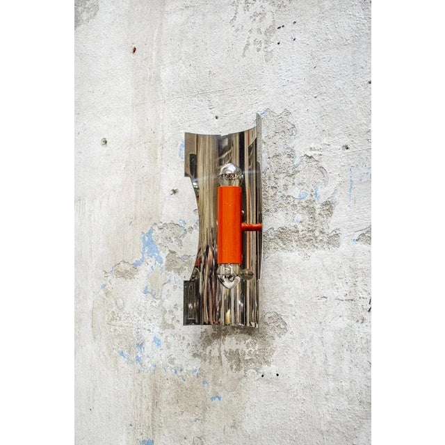 Applique two steel lights and orange lacquered metal. Space Age style Italian Light Manufacturer 60's I have official...