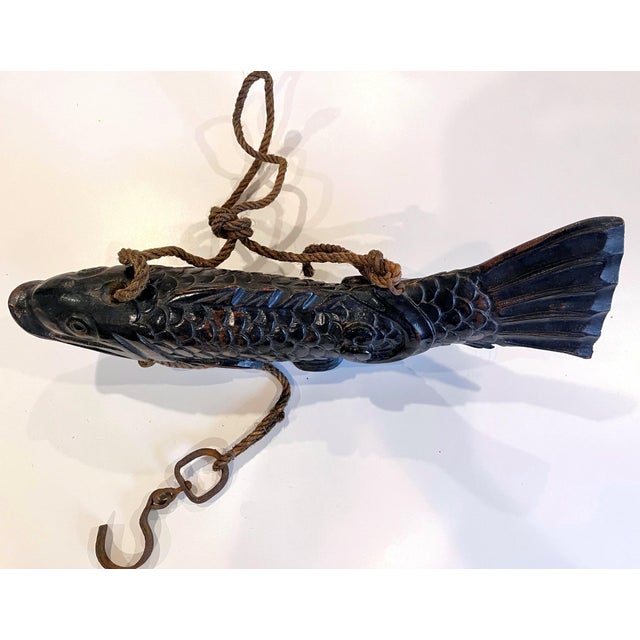A near pair of wood koi fish from Japan circa 1860-90s of late Meiji Period. Hand-carved from solid wood, these sculptures...