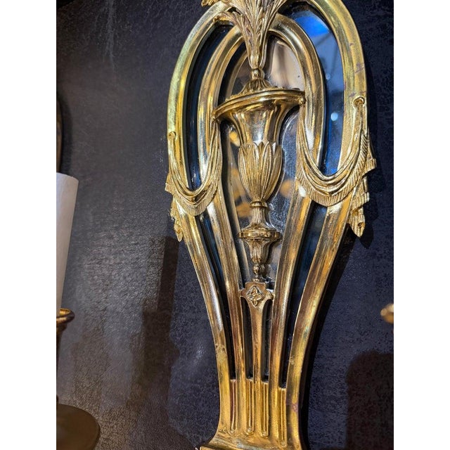 Pair of 1900 Caldwell gilt bronze sconces with mirror and cobalt glass backplate, 2 lights