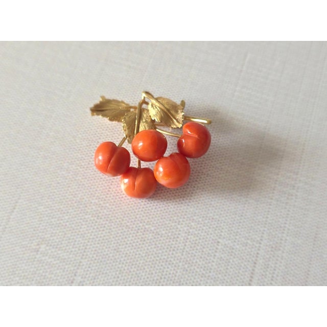 Presenting a delicate and elegant gold brooch in the shape of a cherry branch — a true work of art! This miniature brooch...