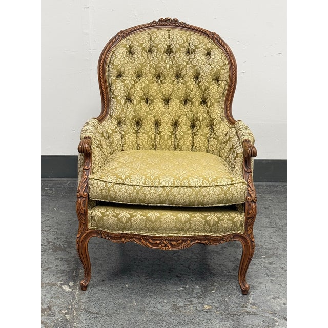 Design Plus Gallery presents a Vintage French Louis XV Style Tufted Bergère Armchair. This ornate armchair showcases a...
